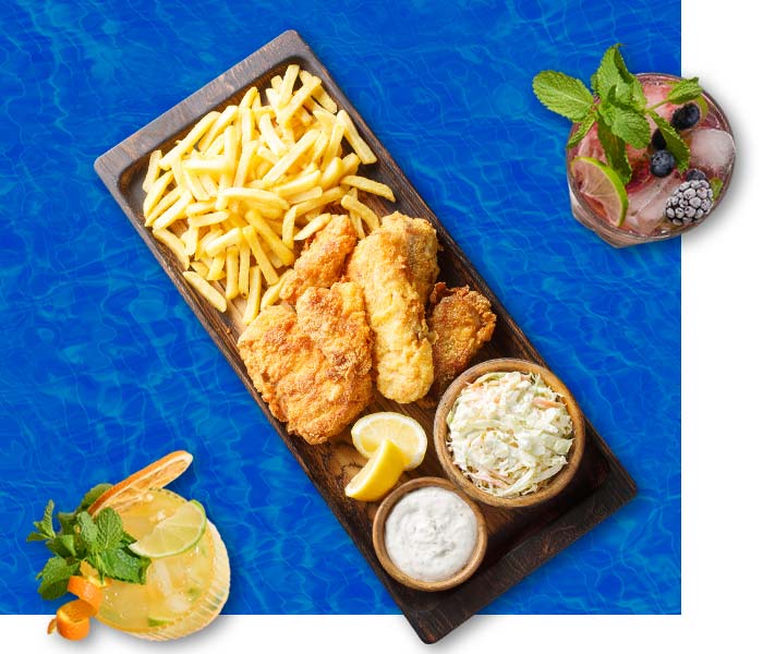 Oceans restaurant in Panama City Beach Florida fish and chips and a side of coleslaw served beside a mint mojito